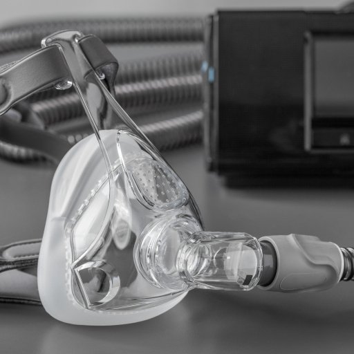 Sleep apnea CPAP mask on the grey table